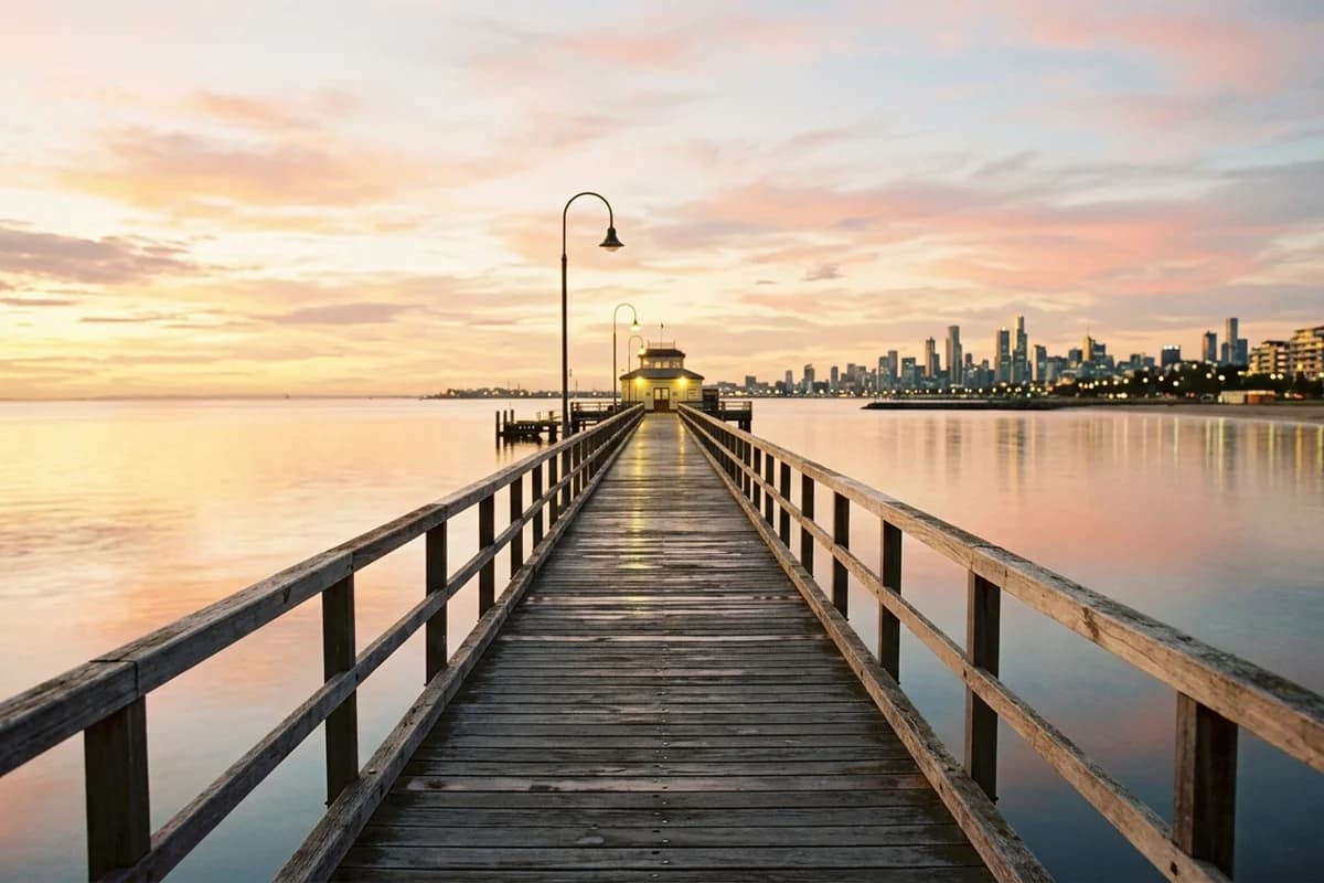 St Kilda Pier at sunset with the Melbourne skyline along the foreshore